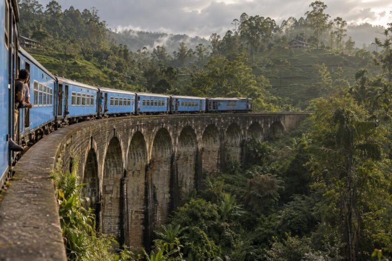 Blue passenger train crossing the Nine Arch Bridge near Ella in Sri Lanka's tea country